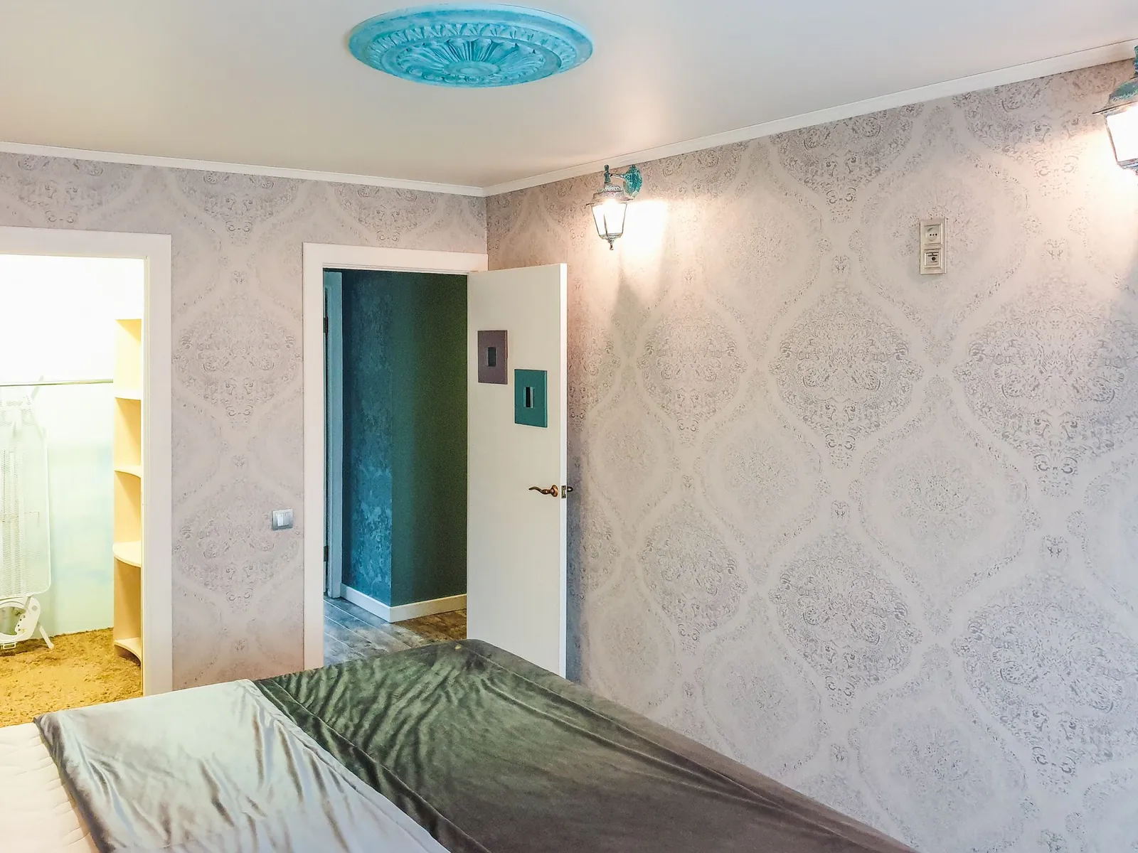 Bright bedroom with elegant silver damask wallpaper and soft natural light